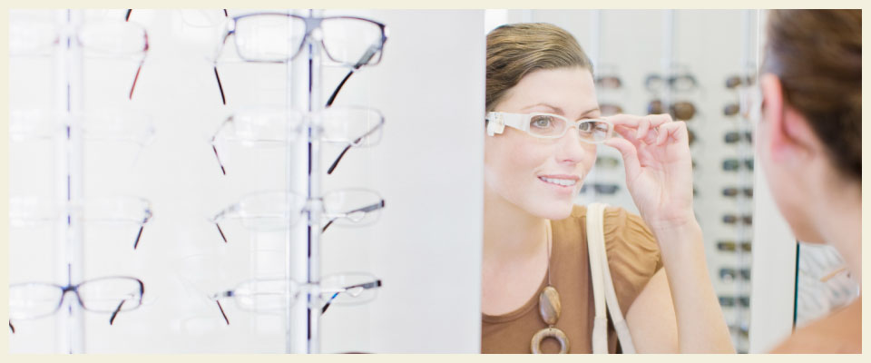 woman trying on glasses and contact lenses in North Battleford